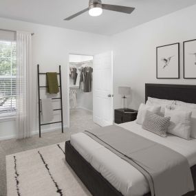 Bedroom with walk-in closet and plush carpet at Camden Panther Creek apartments in Frisco, TX