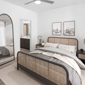 Bedroom with wood-style flooring and ensuite bathroom at Camden Panther Creek apartments in Frisco, TX