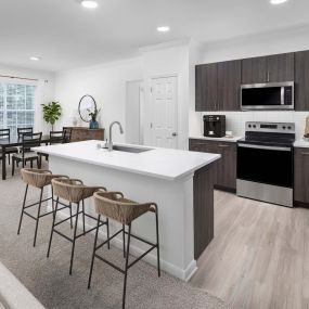 Spacious kitchen with island and dining area at Camden Panther Creek apartments in Frisco, TX