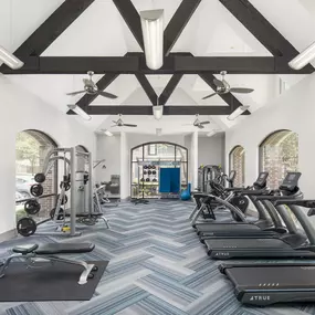 24 hour fitness center with cardio and strength training equipment and free weights