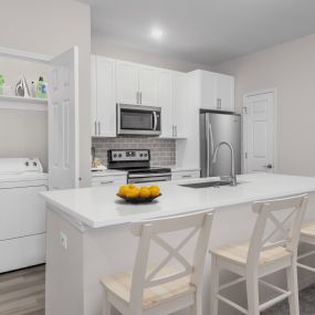 Kitchen with spacious island and full-size washer and dryer