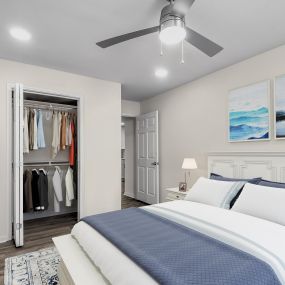 Modern bedroom with hardwood-style flooring, ceiling fan, and recessed lighting throughout