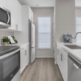 Galley kitchen with window and stainless steel appliances