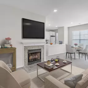 Open-concept living area with fireplace and access to private balcony