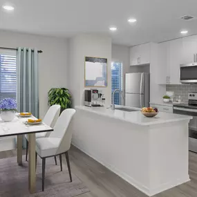 Kitchen and dining area with hardwood-style flooring throughout and lots of windows