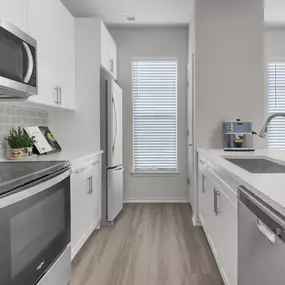 Galley kitchen with window and stainless steel appliances