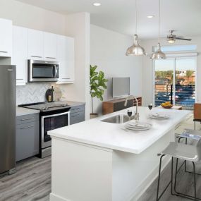 Kitchen with bar seating and white quartz countertops