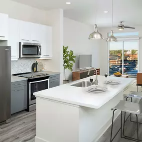 Kitchen with bar seating and white quartz countertops