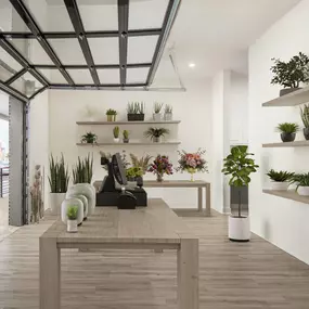 Plant shop business in live-work apartments that is accessible through a window paneled garage door at Camden RiNo Live-Work apartments in Denver, CO