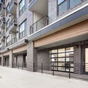 Exterior of the Live-Work Apartments with garage door and street access at Camden RiNo Apartments in Denver, CO.
