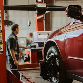 mechanic repairing vehicle alignment