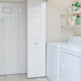 Full-size washer and dryer with shelving and easy access.