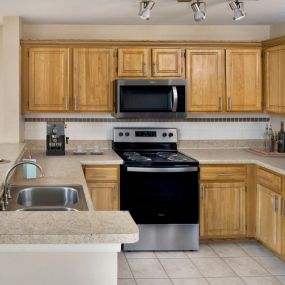 Open concept kitchen with stainless steel appliances including a microwave.