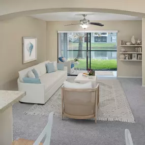 Living room with lighted ceiling fan overlooking the lake.