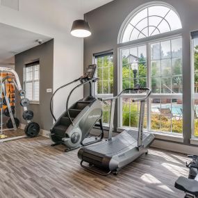 Fitness center with stair climber smith machine row machine and curved treadmill