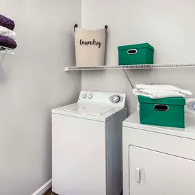 Laundry room with full size washer and dryer and shelving