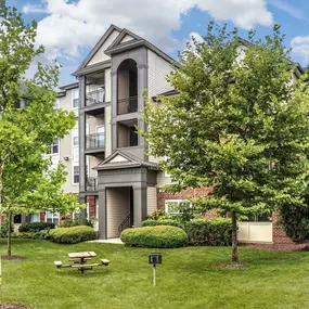 Building exterior showing private balconies and outdoor barbeque and dining areas