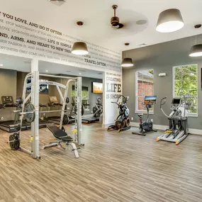 24 hour fitness center with cardio equipment and smith machine