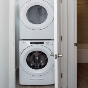 Easy access to clean your clothes in the full size stacked front load washer and dryer at Camden Lake Eola apartments in Orlando, FL.