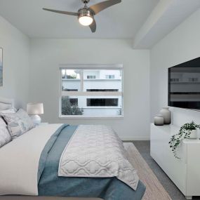 B1 Floor Plan Bedroom with Plush Carpeting at Lighted Ceiling Fan.