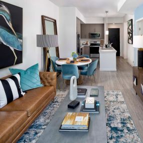 Open concept kitchen and living room with wood-inspired flooring in the A2 floor plan.