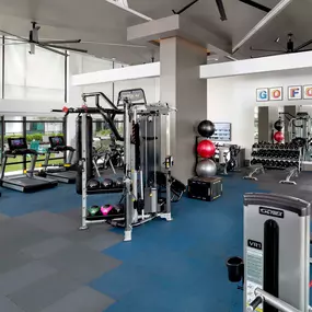 Fitness center on the seventh floor overlooking the pool deck at Camden Lake Eola apartments in Orlando, FL