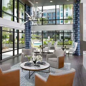 Surrounded by windows overlooking the pool deck, the resident lounge is a great place to gather with friends, have meetings, or get some work done at Camden Lake Eola apartments in Orlando, FL