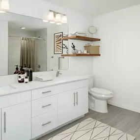 Lovely bathroom with double sink vanity and satin nickel finishes and Moen fixtures at Camden Lake Eola apartments in Orlando, FL