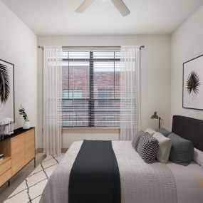 Modern style bedroom with walk-in closet at Camden City Centre Apartments in Houston, TX.