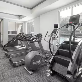 Two Fitness centers with cardio equipment including Peloton, Stairmaster, and treadmills at Camden City Centre Apartments in Midtown Houston, Tx