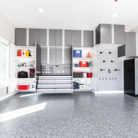 See how organized a garage can be! To upgrade this garage, we added flexible wall storage, and a hide-away workbench. There’s even room for a fridge!