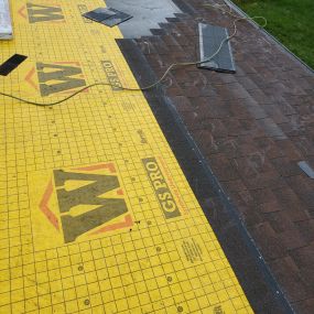 Synthetic Underlayment and shingles being installed on a roof
