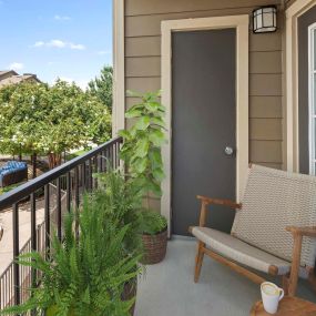 Private balcony with storage closet overlooking pool deck at Camden Amber Oaks apartments in Austin, TX