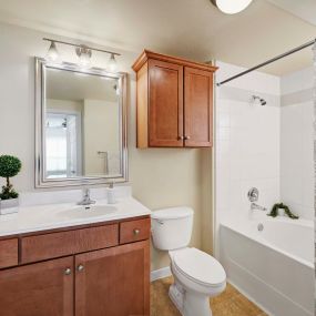 Bathroom with bathtub with tile surround and straight shower rod