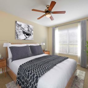 Bedroom with beige walls and ceiling fan