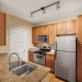 Kitchen with electric coil cooktop and stainless steel appliances