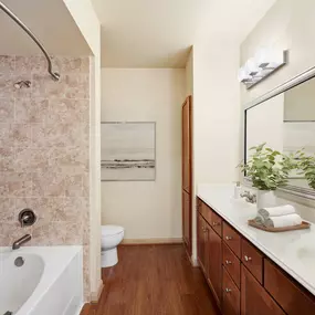 Bathroom with tile bathtub surround at Camden Amber Oaks apartments in Austin, TX