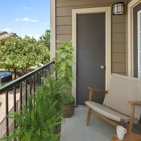 Private balcony with storage closet overlooking pool deck at Camden Amber Oaks apartments in Austin, TX