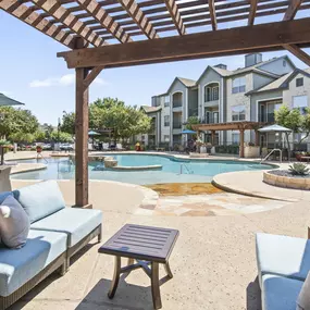 Poolside covered lounge seating at Camden Amber Oaks apartments in Austin, TX