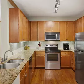 Kitchen with stainless steel appliances and granite countertops at Camden Amber Oaks apartments in Austin, TX