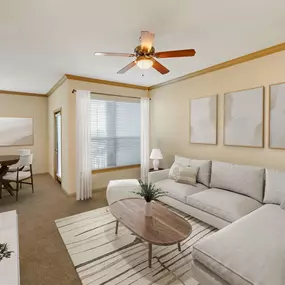 Living room with carpet and private balcony at Camden Amber Oaks apartments in Austin, TX