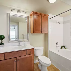 Bathroom with bathtub with tile surround and straight shower rod