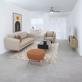 Living room with ceiling fan and carpet flooring at Camden Royal Palms apartments in Tampa, FL