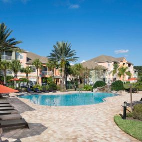 Pool with lounge chairs and outdoor dining area