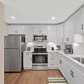 a large white kitchen with a white counter top
