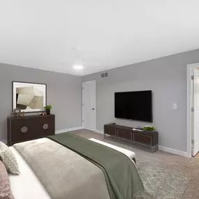 Bedroom with a large bed and a television on the wall