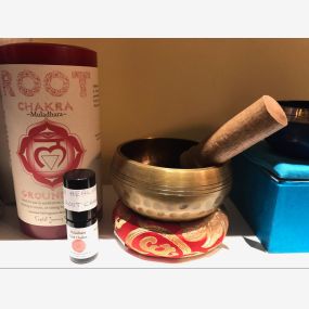 Chakra singing bowl, candle and oil that can be used to help balance chakras.