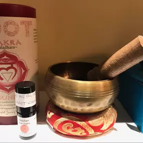 Chakra singing bowl, candle and oil that can be used to help balance chakras.