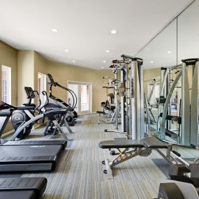 Fitness center with cardio equipment and free weights at Camden Stonebridge Apartments in Houston, TX