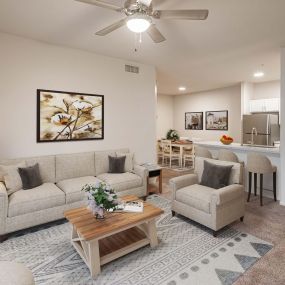 Open concept living room with ceiling fan and dining area and barstool seating